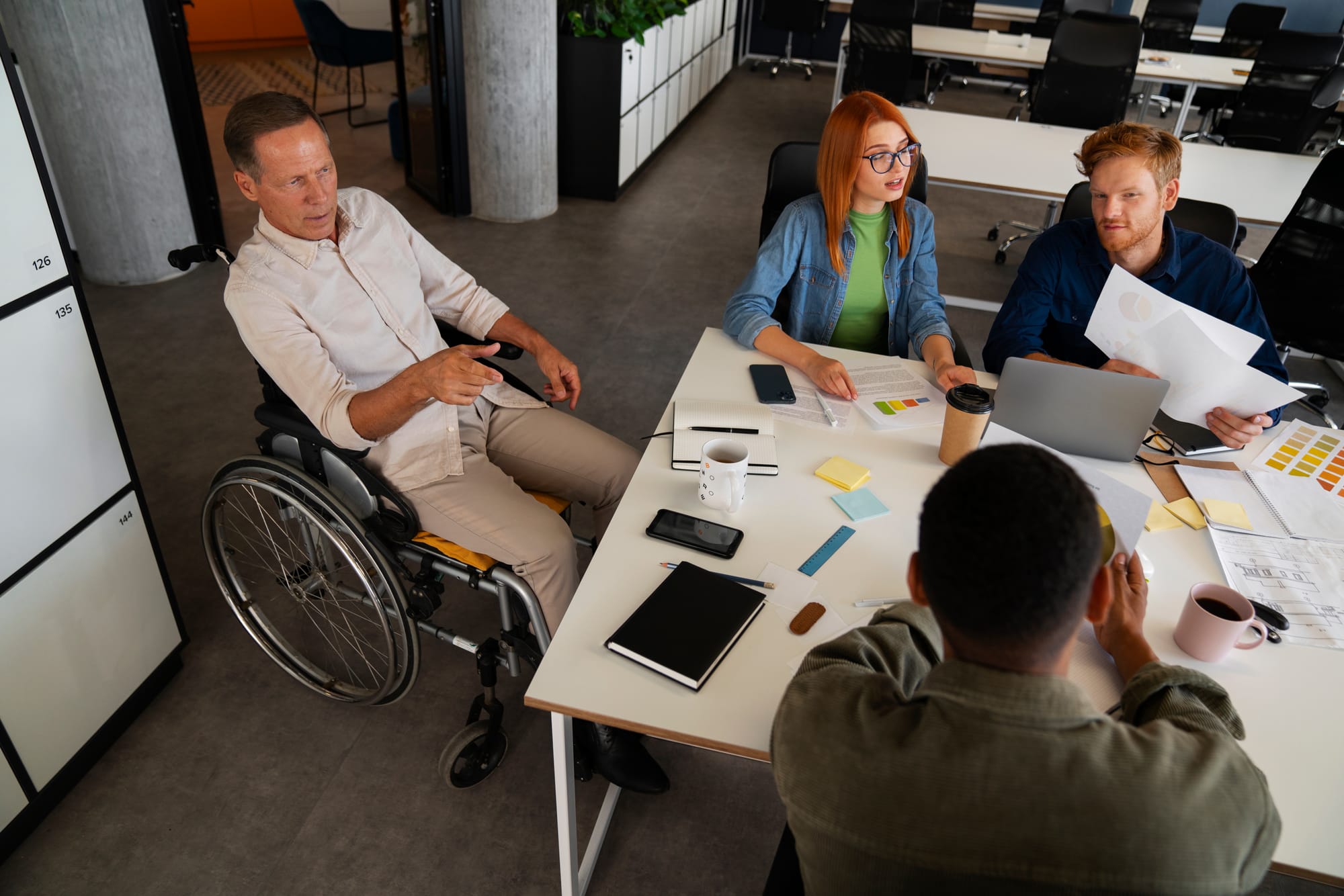 A disabled person in a wheelchair working in an accessible coworking space