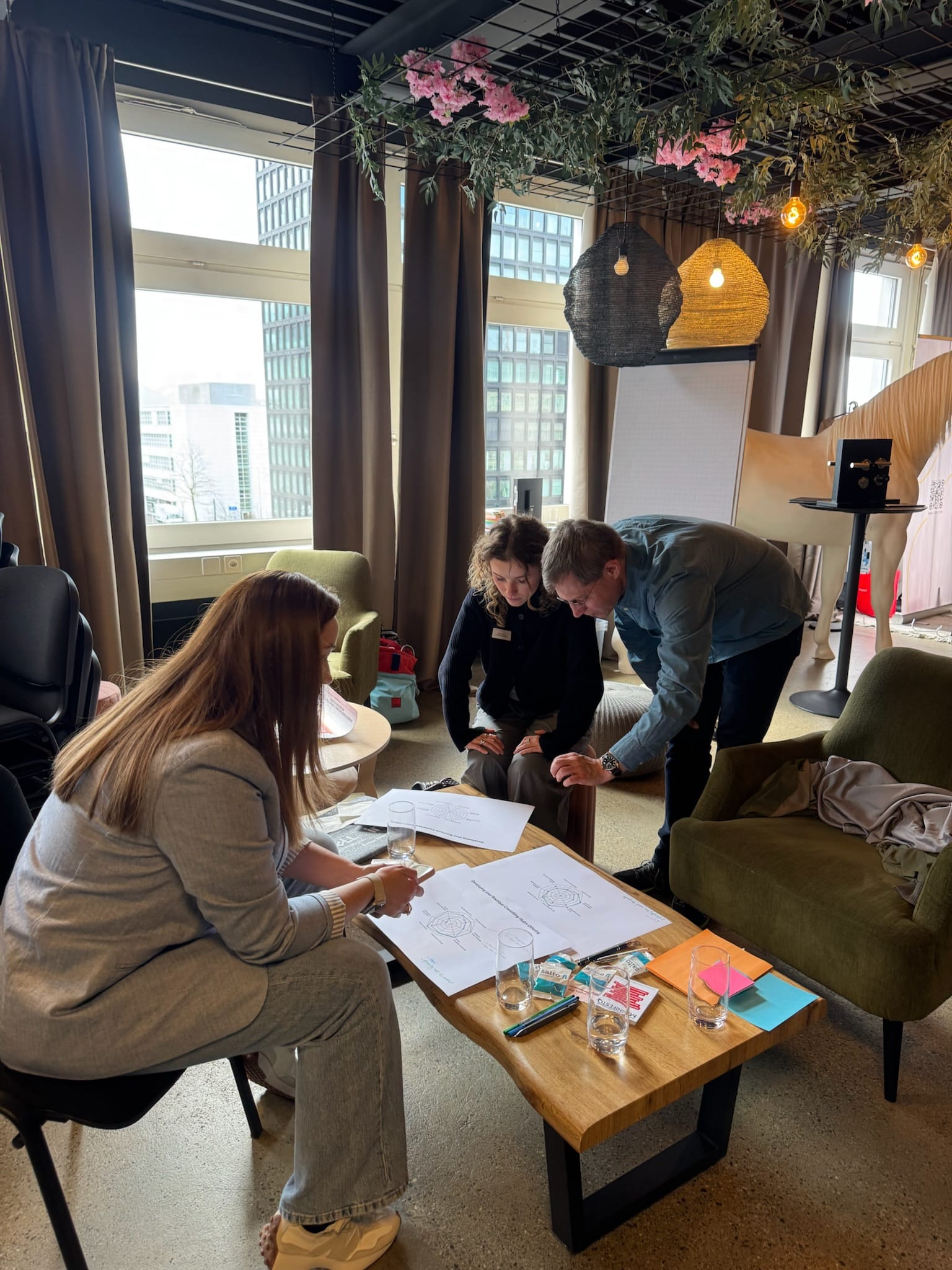 Mélanie presenting "The Swiss Office Scene" slide at CV Labs, with audience members seated in front.