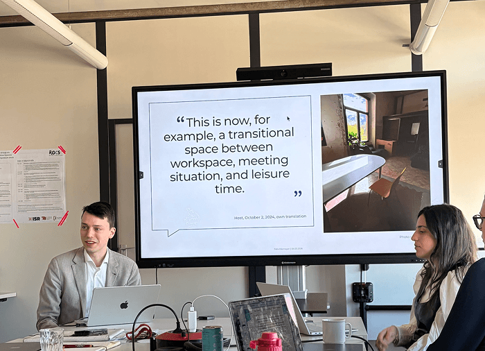 Felix Hiemeyer presenting research on coworkation and the relationship between work, hospitality, and collaborative environments.